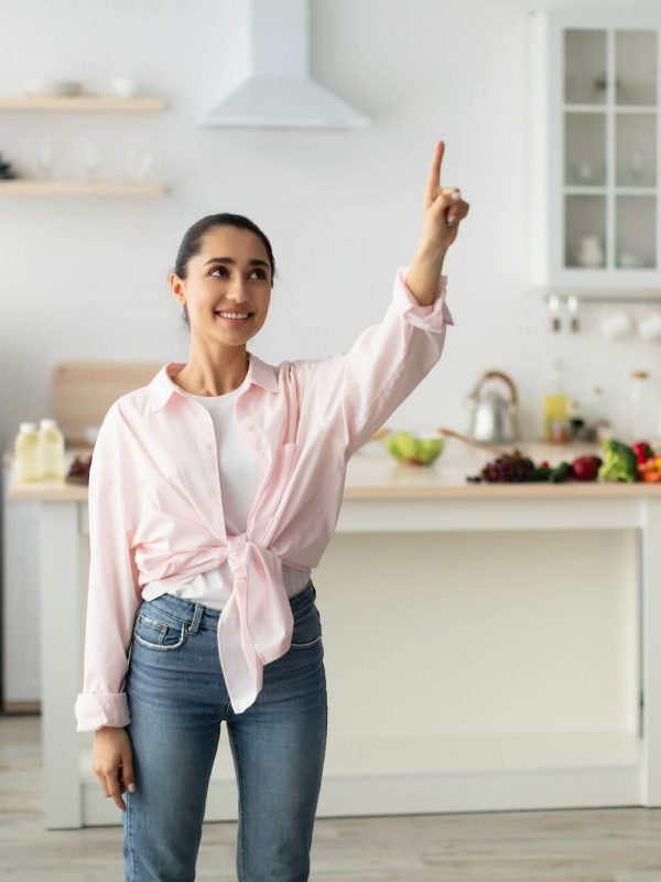 smart-home-concept-millennial-woman-pointing-finger-up-in-air.jpg